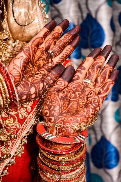 Indian bride showing hands mehndi design on wedding