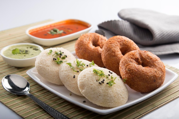 Indian buns on a plate next to sauces on the table