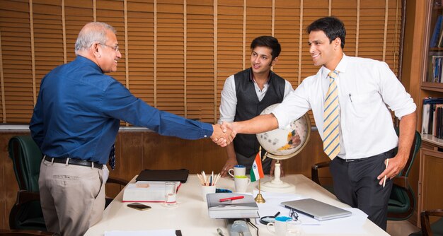 Photo indian business people in corporate culture working in the office shaking hands to close a deal