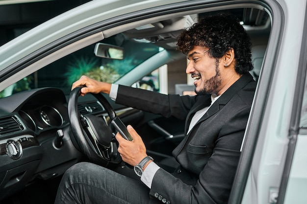 Uomo d'affari indiano alla guida della sua auto.