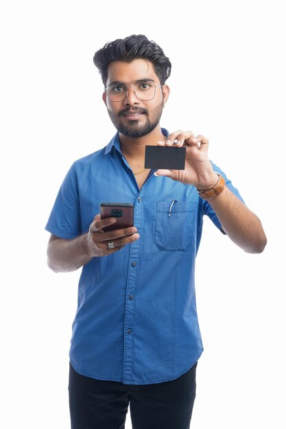 Indian businessman holding credit card and using phone