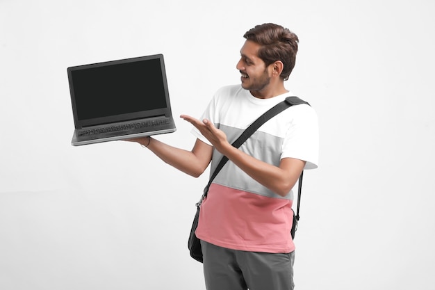 Indian college student showing laptop screen