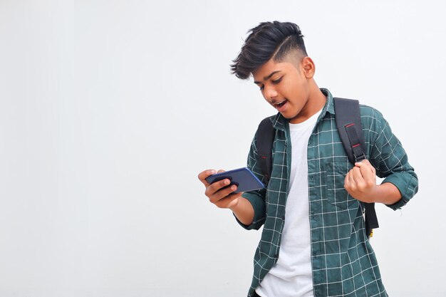 Indian college student using smartphone on white background