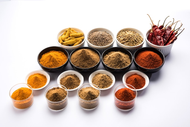 Indian colourful spices. Group photo of four basic Indian spices like raw red chilli, turmeric, coriander and cumin powder. selective focus