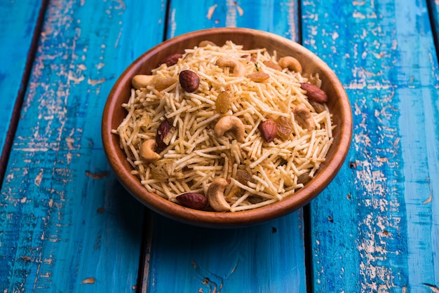 Indian deep fried Falahari chivda also known as Fasting or Upwas chiwada made using potato and dry fruits for Navaratri or any hindu vrat. Served in a wooden bowl. Selective focus