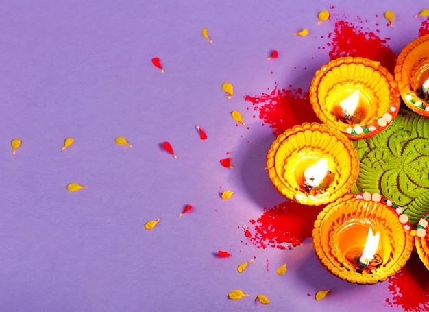 Indian diwali diya oil lamps lit on beautiful colorful rangoli diwali concept