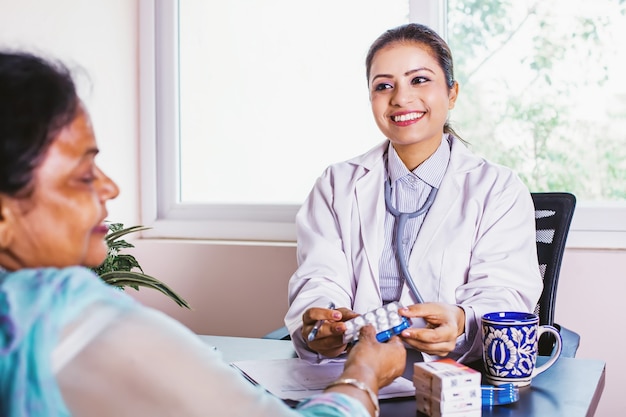 Indian doctor consulting an elderly patient