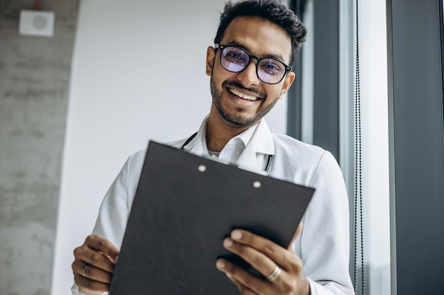 Indian doctor reading prescription at clinics