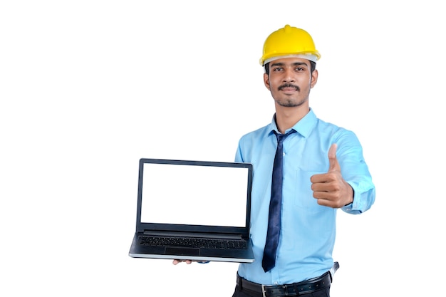 Indian engineer showing laptop empty screen on white background.