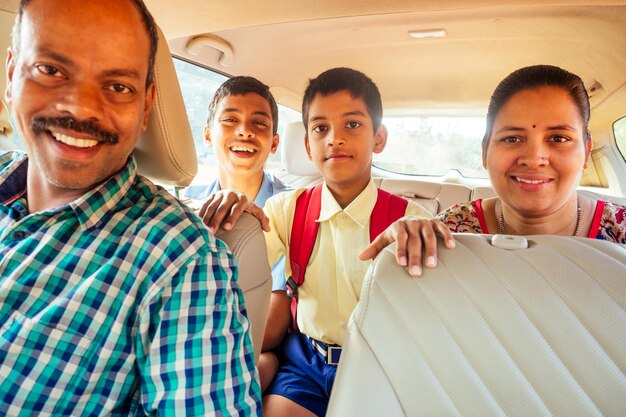 Indian family buying a new car and ready to go on beach\
vacation