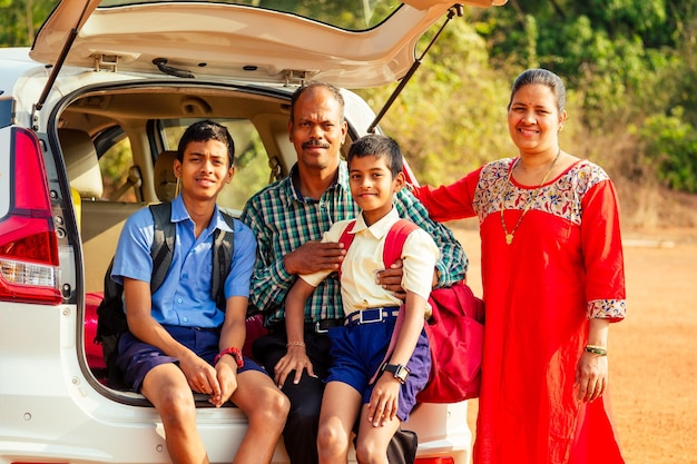 Indian family buying a new car and ready to go on beach vacation