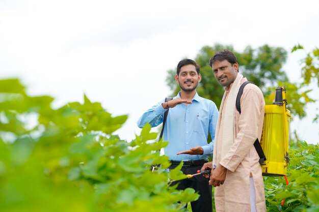 インドの農民が農場で農学者と話し合い、いくつかの情報を収集している