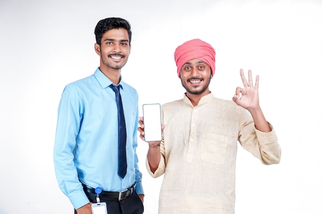 Indian Farmer showing smartphone with officer on white background.