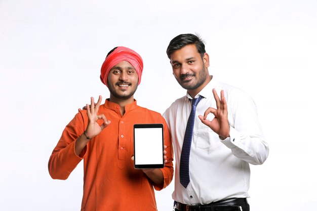 Indian Farmer showing tablet with bank officer or corporate government employee on white background.