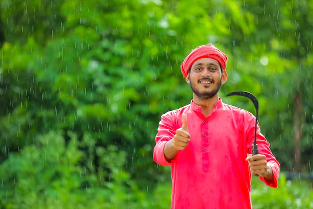 Indian farmer standing in a sorghum field