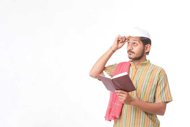 Photo indian farmer using diary on white background.