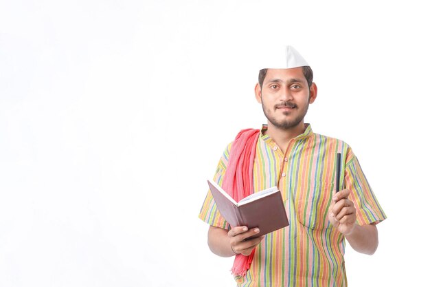 Photo indian farmer using diary on white background.