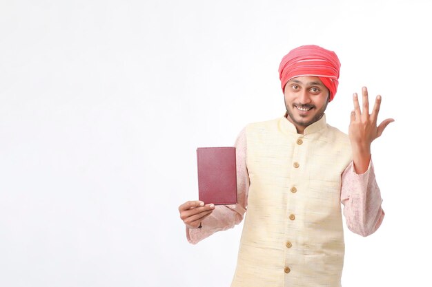 Photo indian farmer using diary on white background.