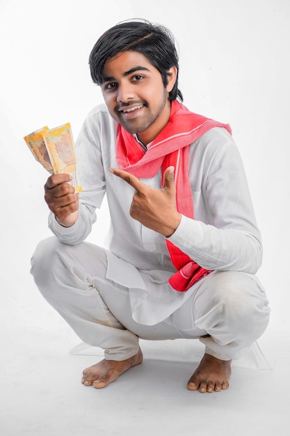 Indian farmer with currency notes on a white background