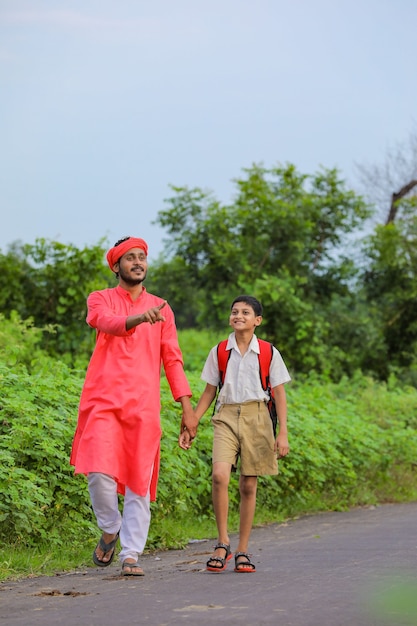 Indian farmer with his child on the road