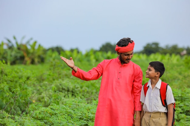 Indian farmer with his child on the road