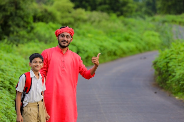 Indian farmer with his child on the road