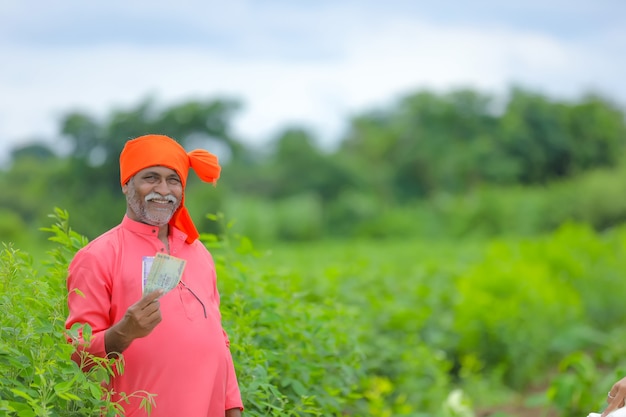 Indian farmer with money and tablet