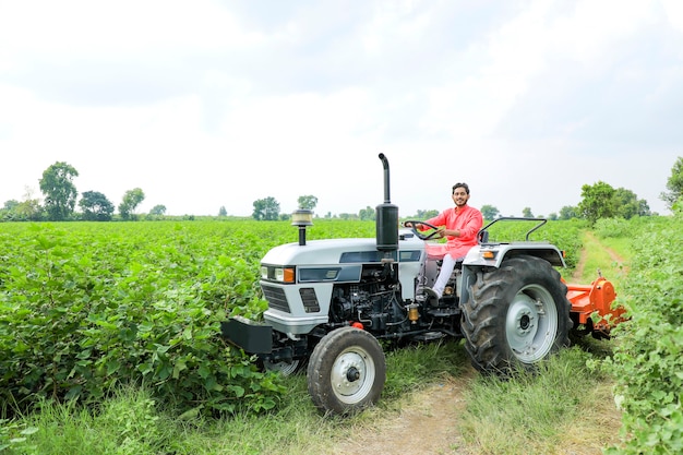 Indian farmer working with tractor at field