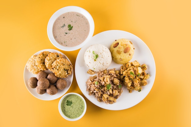 Indian Fasting Recipes or Upwas Food, for Navratri , Maha Shivratri or Ekadasi or Chaturthi or Gauri vrat. Served in ceramic crockery over colourful or wooden background. Selective focus