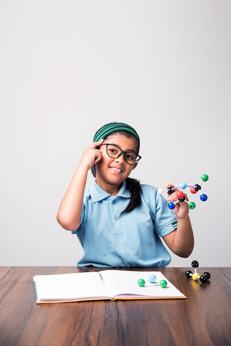 Photo indian female student using molecular model kit for studying science, selective focus