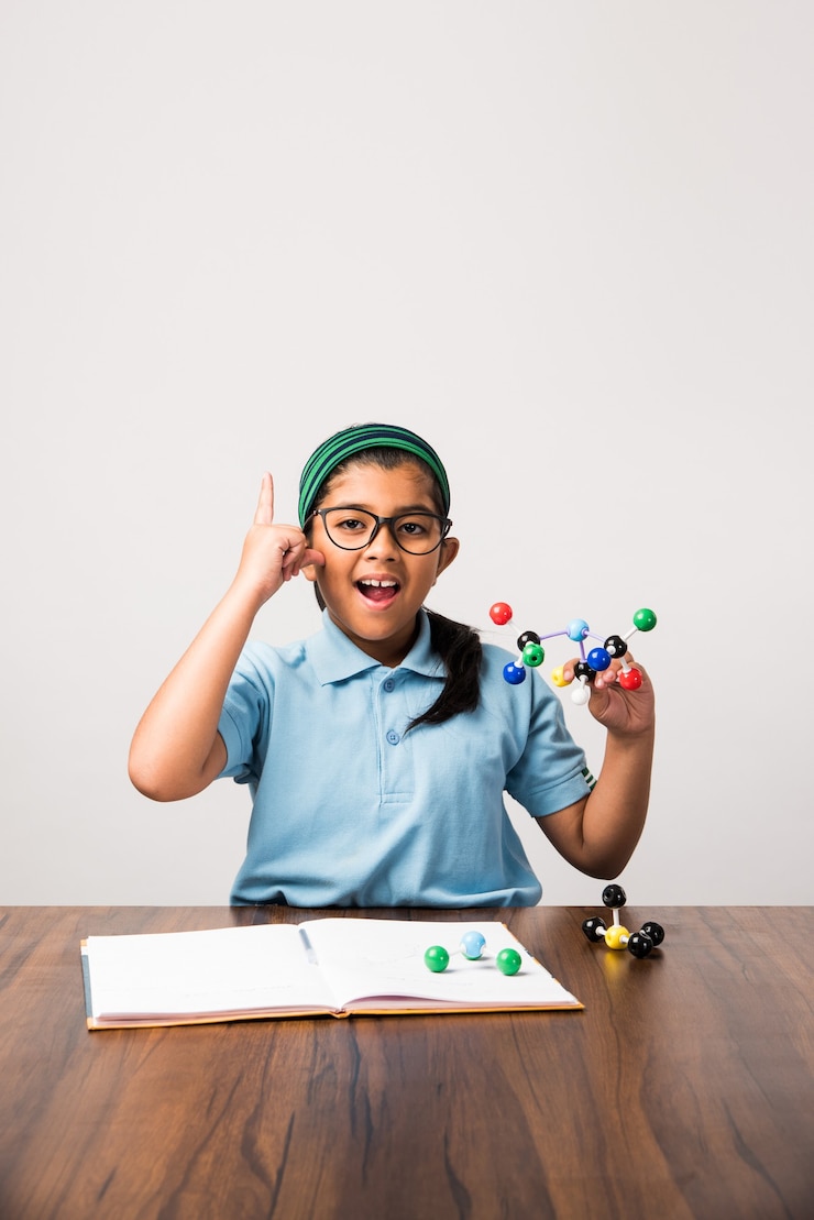 Photo indian female student using molecular model kit for studying science, selective focus
