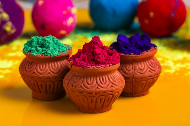 Indian Festival Holi, Multicolor's wooden bowl on yellow surface