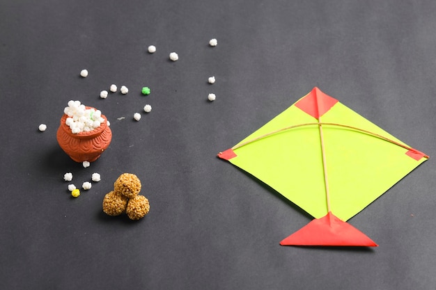 Indian festival makar sankranti concept, Colorful kite ,string and sweet sesame seed ball.