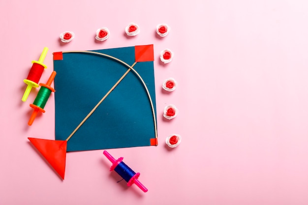 Indian festival makar sankranti concept, Colorful kite ,string and sweet sesame seed ball.