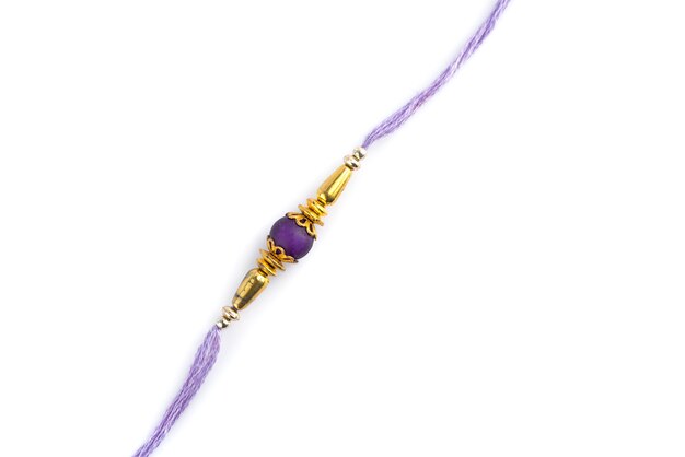 Indian festival: Raksha Bandhan background with an elegant Rakhi on a white background