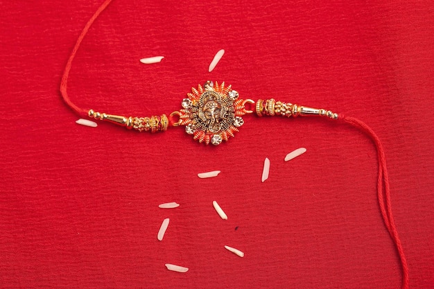 Indian festival Raksha Bandhan A traditional Indian wrist band on red background