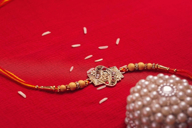 Indian festival Raksha Bandhan A traditional Indian wrist band on red background