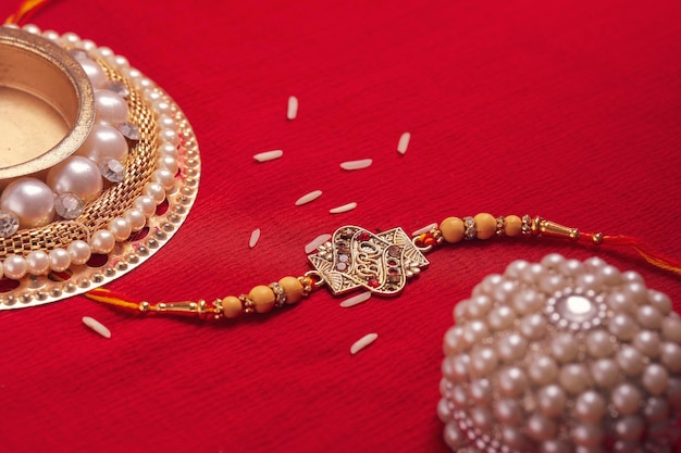 Indian festival Raksha Bandhan A traditional Indian wrist band on red background