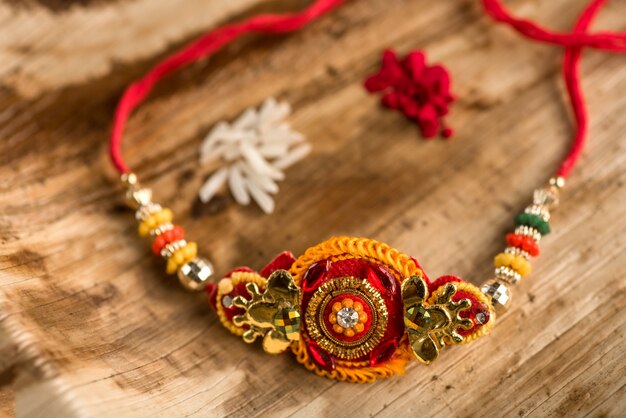 Indian festival: Raksha Bandhan with an elegant Rakhi, Rice Grains and Kumkum. A traditional Indian wrist band which is a symbol of love between Brothers and Sisters.