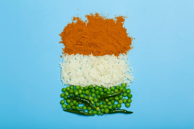 Indian flag made from food background basmati rice curry green peas and chili peppers in the colors ...