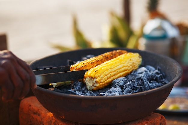 Indian food on the beach - fresh corn cobs are roasted on the coals.