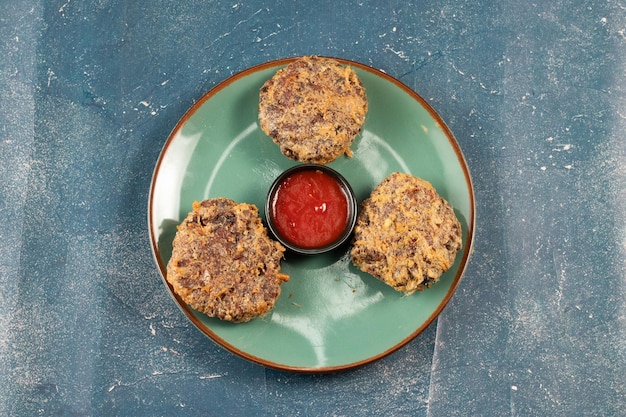 Indian food jali kabab with tomato sauce served in a dish\
isolated on background top view