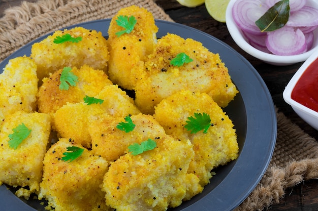 Indian Food Khaman Dhokla on Wooden Background