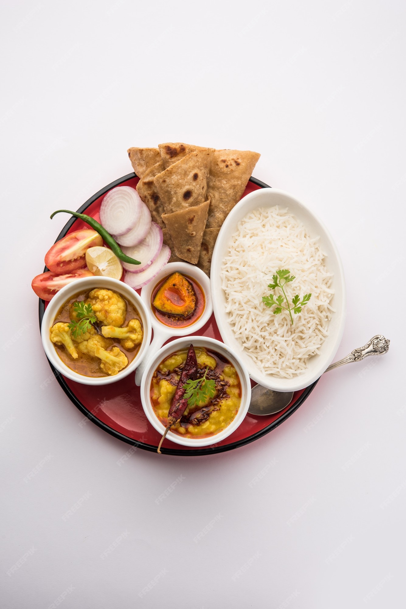 Premium Photo Indian Food Platter Or Vegetarian Thali Includes Dal Fry Rice Chapati And A Type Of Vegetable With Salad