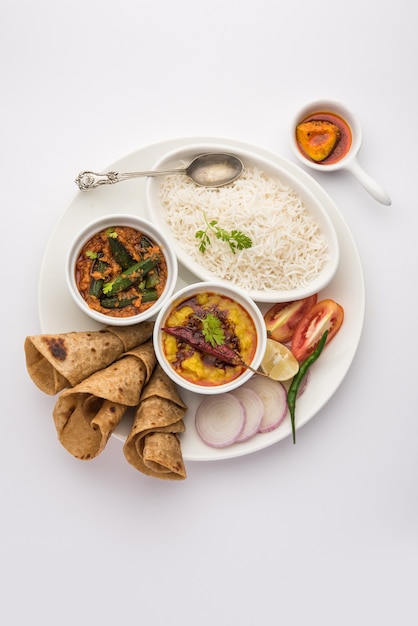 Indian Food Platter or Vegetarian Thali includes Dal Fry, Rice, Chapati and a type of vegetable with salad