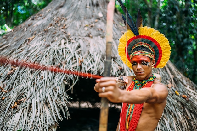 Indian from the PataxÃ³ tribe using a bow and arrow