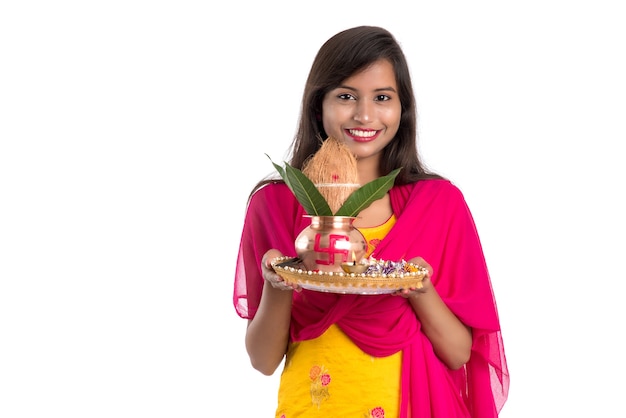 Indian girl holding a traditional copper Kalash with Pooja Thali, Indian Festival