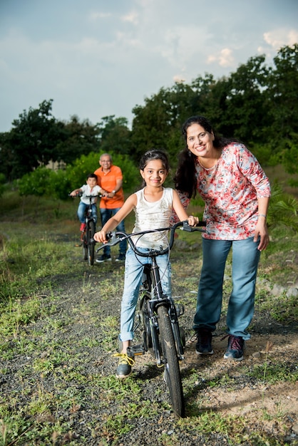 Indian girl learning to ride on bicycle, balancing