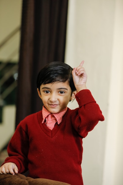 Indian girl in school uniform and showing finger