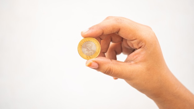 Indian girl showing a head side of tenrupee coin